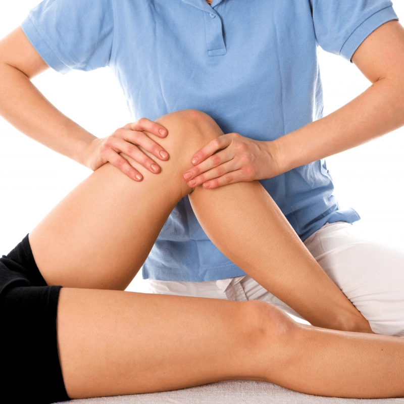 Physiotherapist assessing a patient’s knee